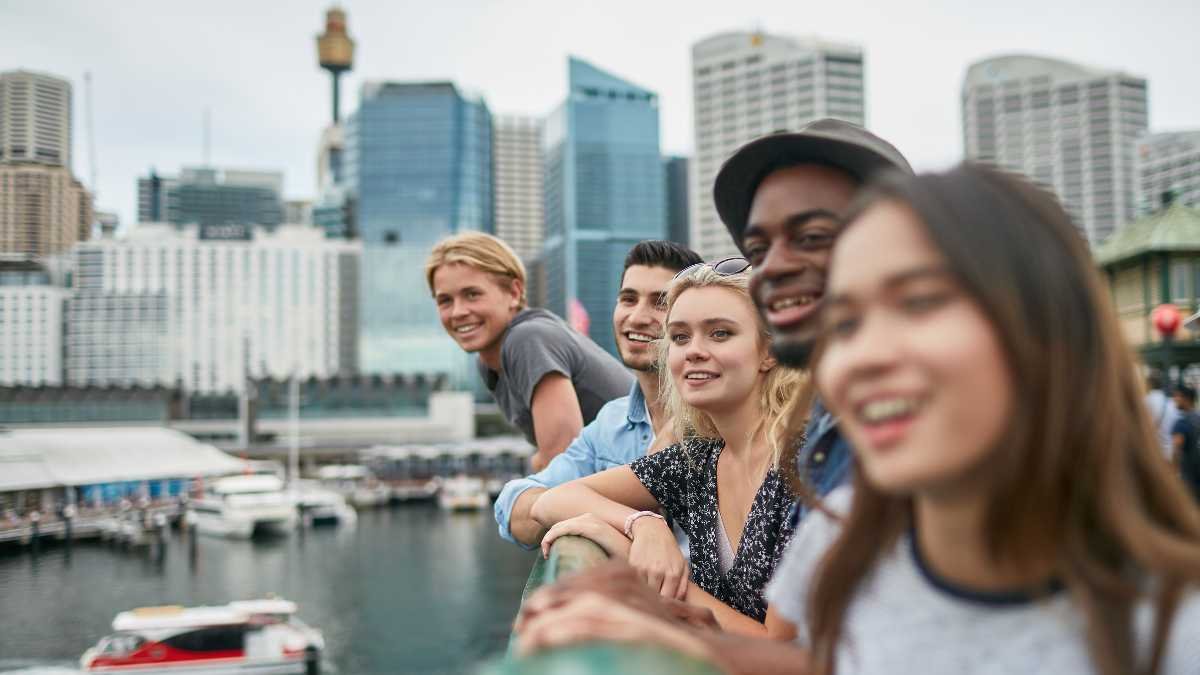 Group of friends smiling by city waterfront