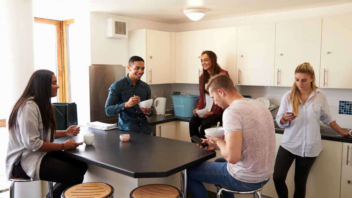 Group of friends socializing in kitchen