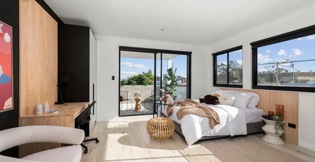Modern bedroom with balcony and contemporary furniture.