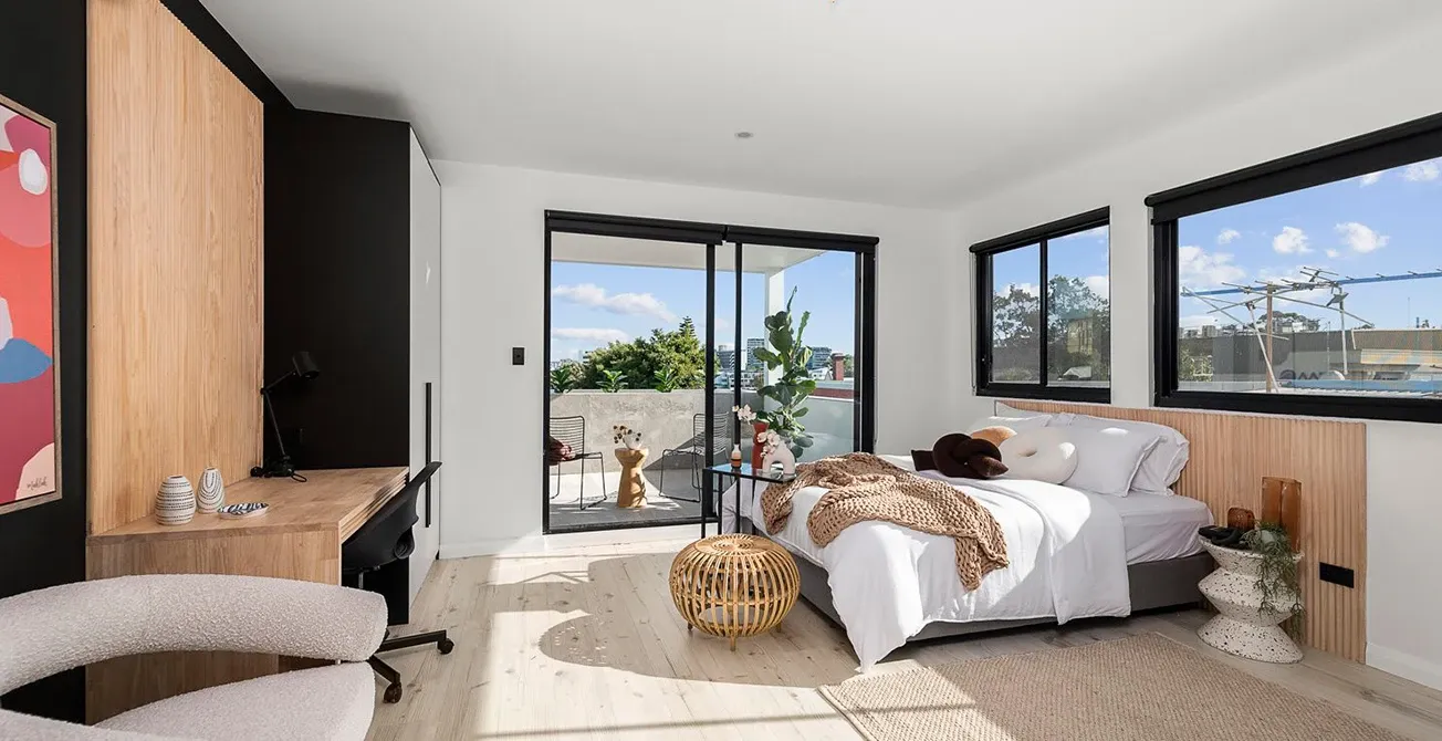 Modern bedroom with balcony and contemporary furniture.